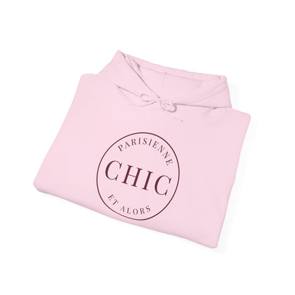A folded light pink hoodie with a circular dark brown graphic on the front reading 'PARISIENNE CHIC ET ALORS', shown on a clean white background.