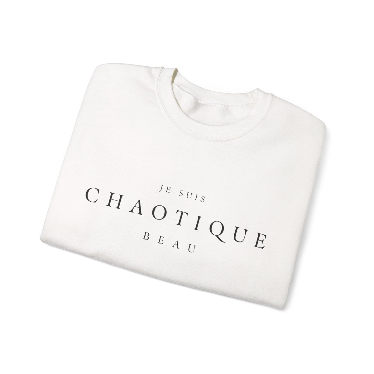 Folded off-white crewneck sweatshirt with 'JE SUIS CHAOTIQUE BEAU' printed in black serif text on the chest, displayed on a clean white background.