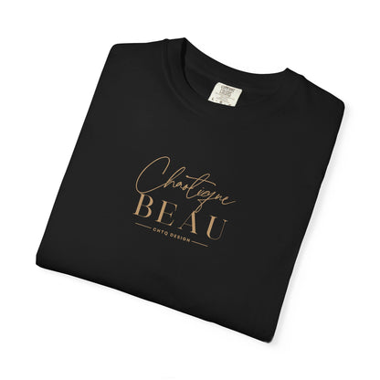 Folded Black Chaotique Beau CHTQ Design graphic T-shirt with a gold-toned front print, shown against a white background.