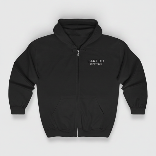 A black zip-up hoodie featuring the white "L'ART DU CHAOTIQUE" graphic on the left chest, displayed against a light gray background.