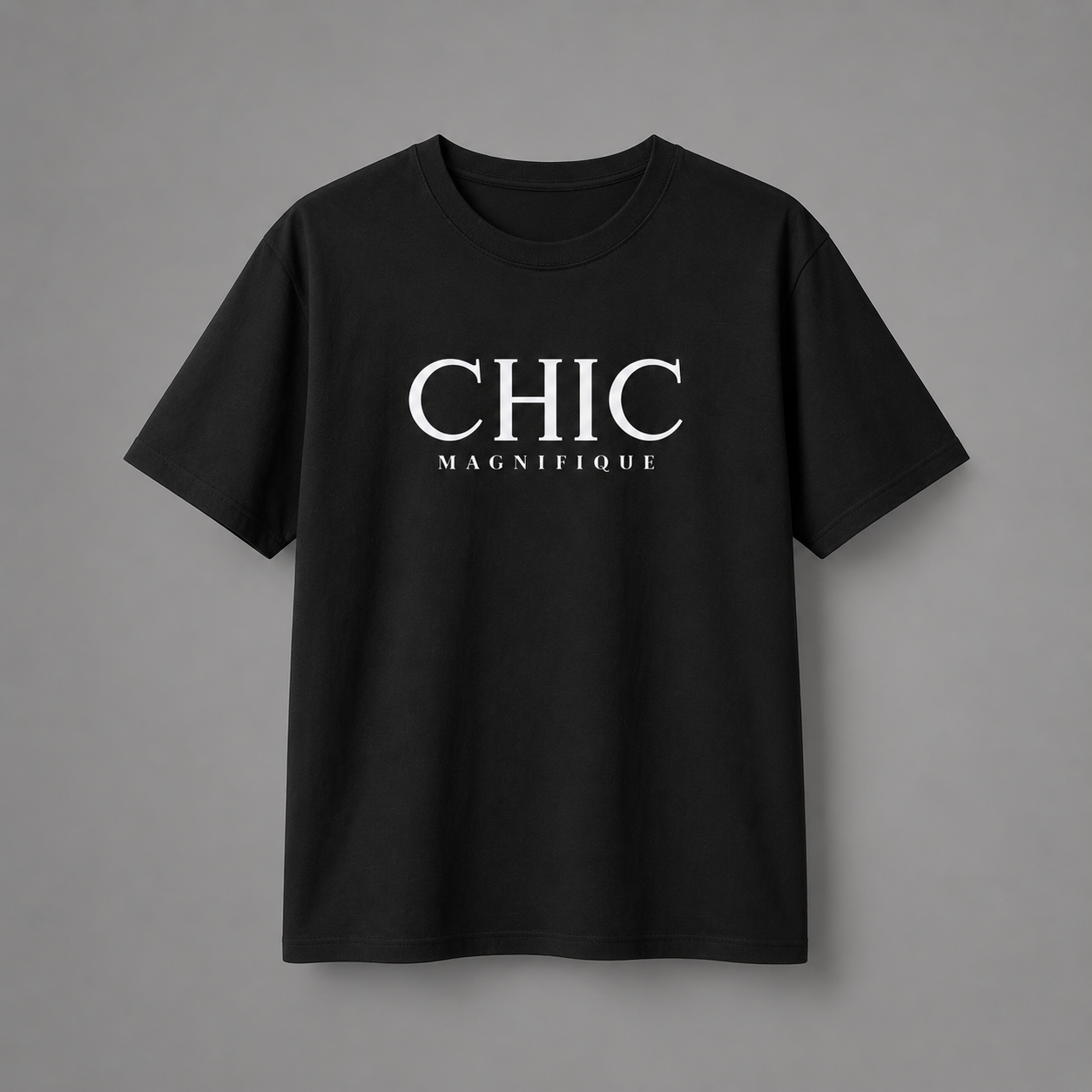 Black CHIC MAGNIFIQUE graphic T-shirt featuring minimalist white French-inspired typography on the chest, displayed against a clean light gray studio background.