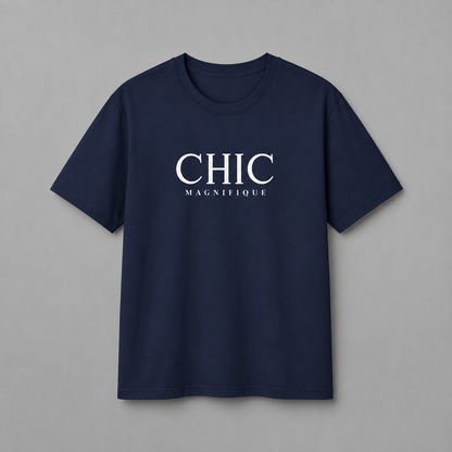 Navy blue CHIC MAGNIFIQUE graphic T-shirt featuring minimalist white French-inspired typography on the chest, displayed against a clean light gray studio background.