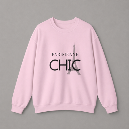 Light pink crewneck sweatshirt featuring a “PARISIENNE CHIC” graphic with a stylized Eiffel Tower, displayed against a neutral gray studio background.