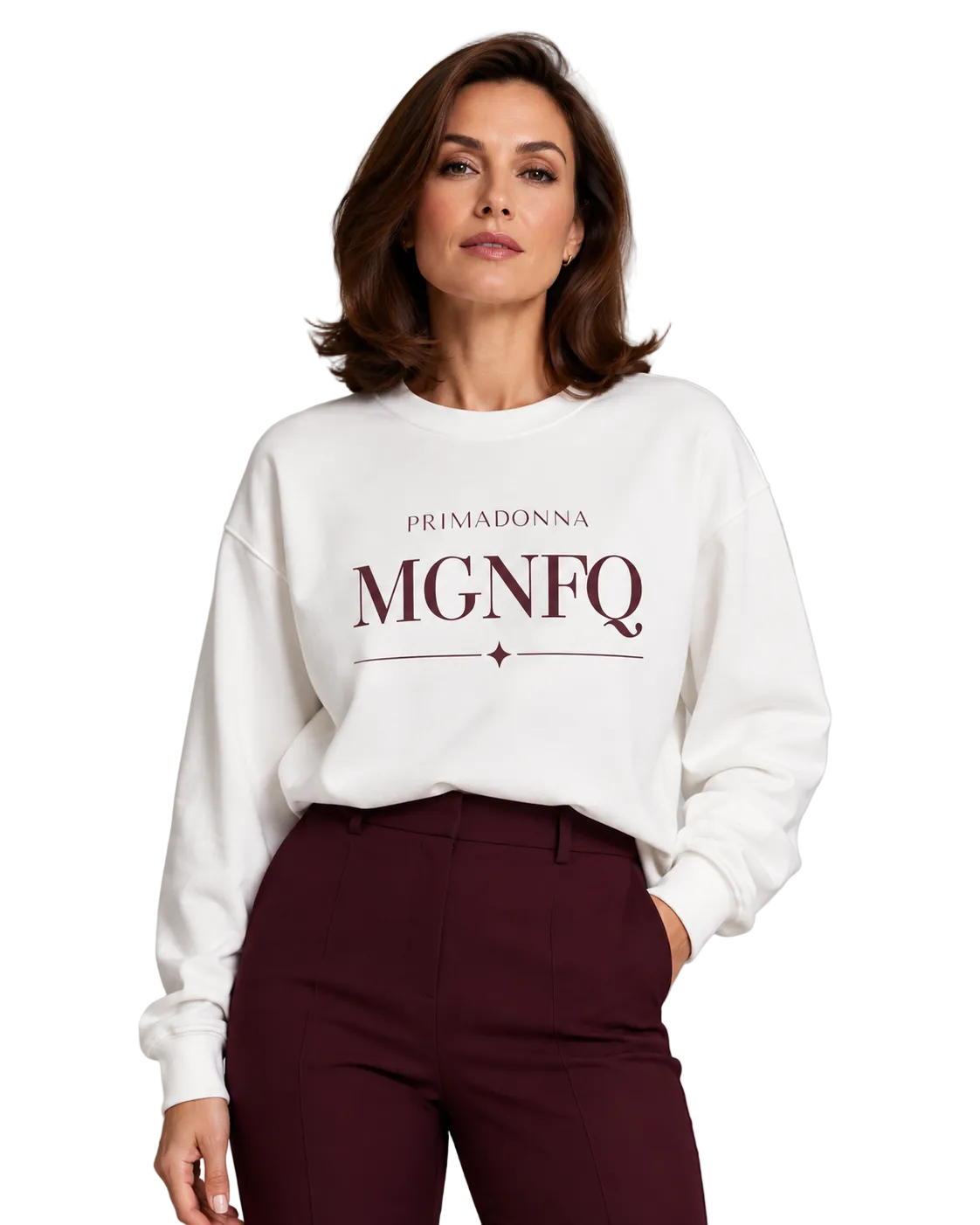 A woman wearing a white crewneck sweatshirt with 'PRIMADONNA MGNFQ' printed in dark burgundy on the front, paired with dark burgundy trousers, against a solid light gray studio background.