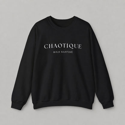 Black sweatshirt on a white background featuring a “Chaotique Mais Raffiné” graphic text print.