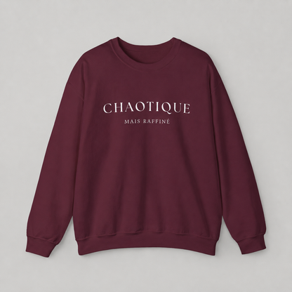 Maroon sweatshirt on a white background featuring a “Chaotique Mais Raffiné” graphic text print.