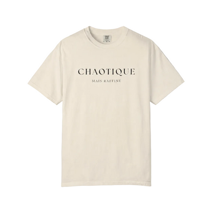 An off-white short-sleeve crewneck t-shirt with 'CHAOTIQUE MAIS RAFFINE' printed in black serif font on the chest, displayed flat against a neutral gray background.