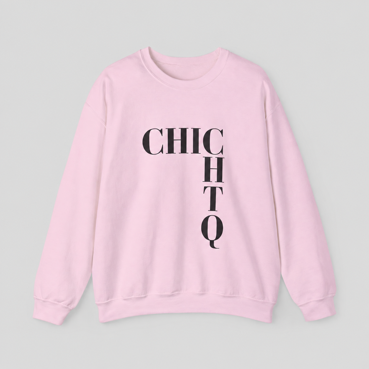 A light pink crewneck sweatshirt with the word 'CHICHTQ' printed in bold black letters across the chest, laid flat against a light gray background.