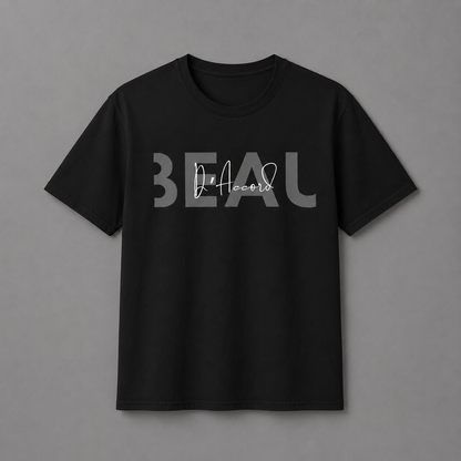 Black short-sleeve crewneck T-shirt featuring a gray “BEAU” graphic with a white cursive “D’Accord” overlay, displayed against a neutral gray studio background.