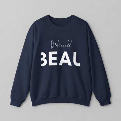 A navy blue crewneck sweatshirt featuring a black “D’accord” script graphic above bold “BEAU” lettering across the chest, displayed against a neutral light gray background.
