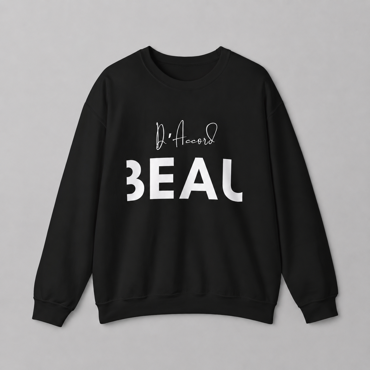 A black crewneck sweatshirt featuring a black “D’accord” script graphic above bold “BEAU” lettering across the chest, displayed against a neutral light gray background.