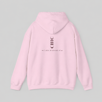 A light pink pullover hoodie featuring a dark brown vertical CHIC back graphic and French-inspired typography, photographed from behind against a clean light gray studio background.
