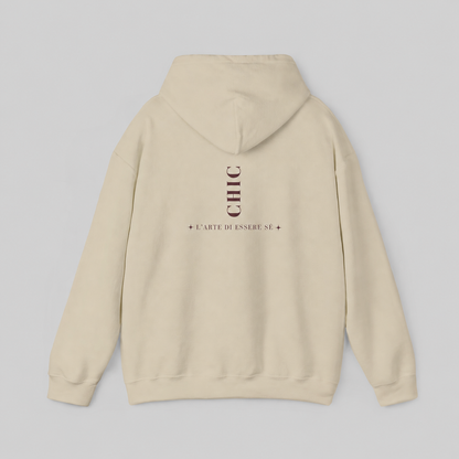 A cream-colored pullover hoodie featuring a dark brown vertical CHIC back graphic and French-inspired typography, photographed from behind against a clean light gray studio background.