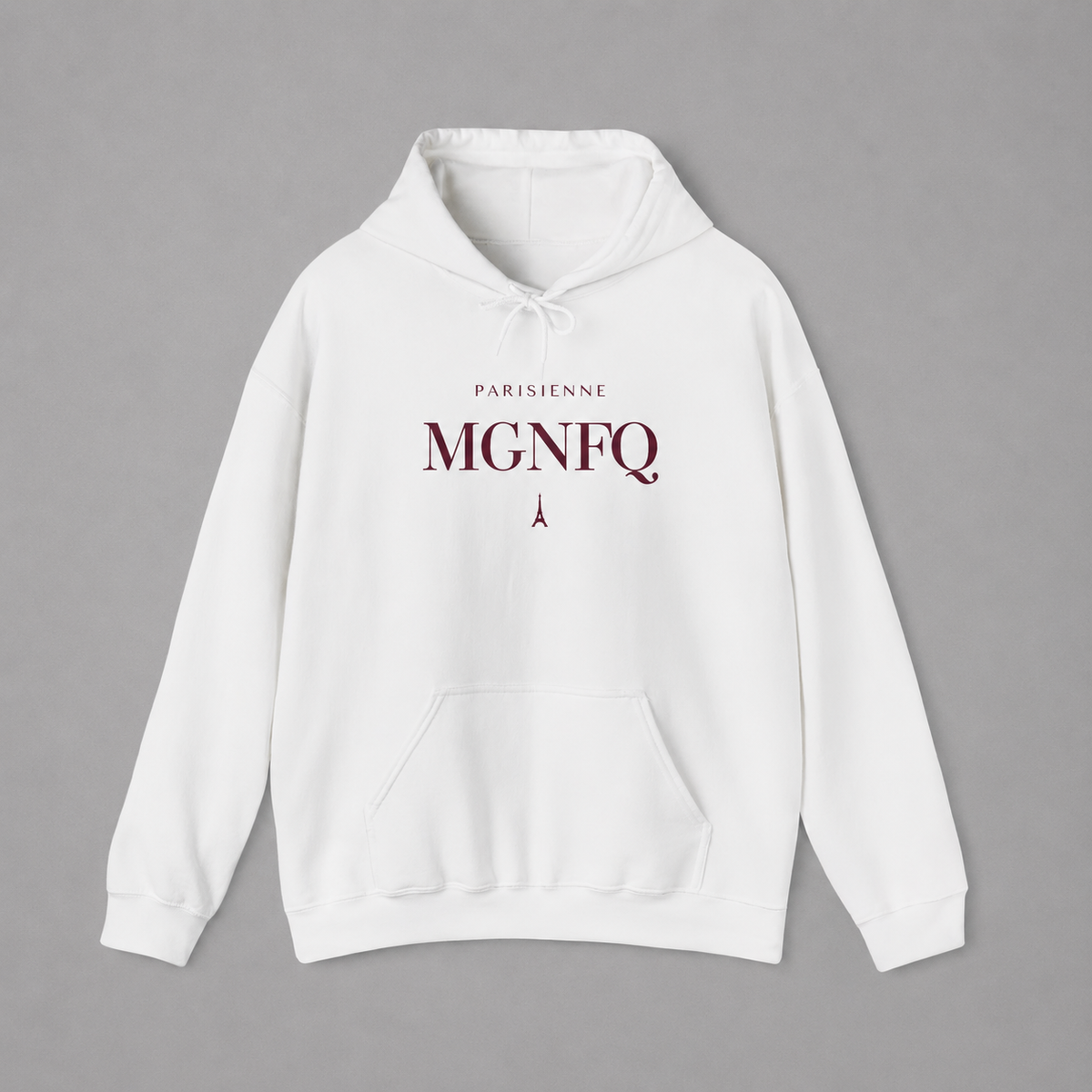 White PARISIENNE MGNFQ graphic hoodie featuring cream typography and a small Eiffel Tower detail, shown against a light gray studio background.