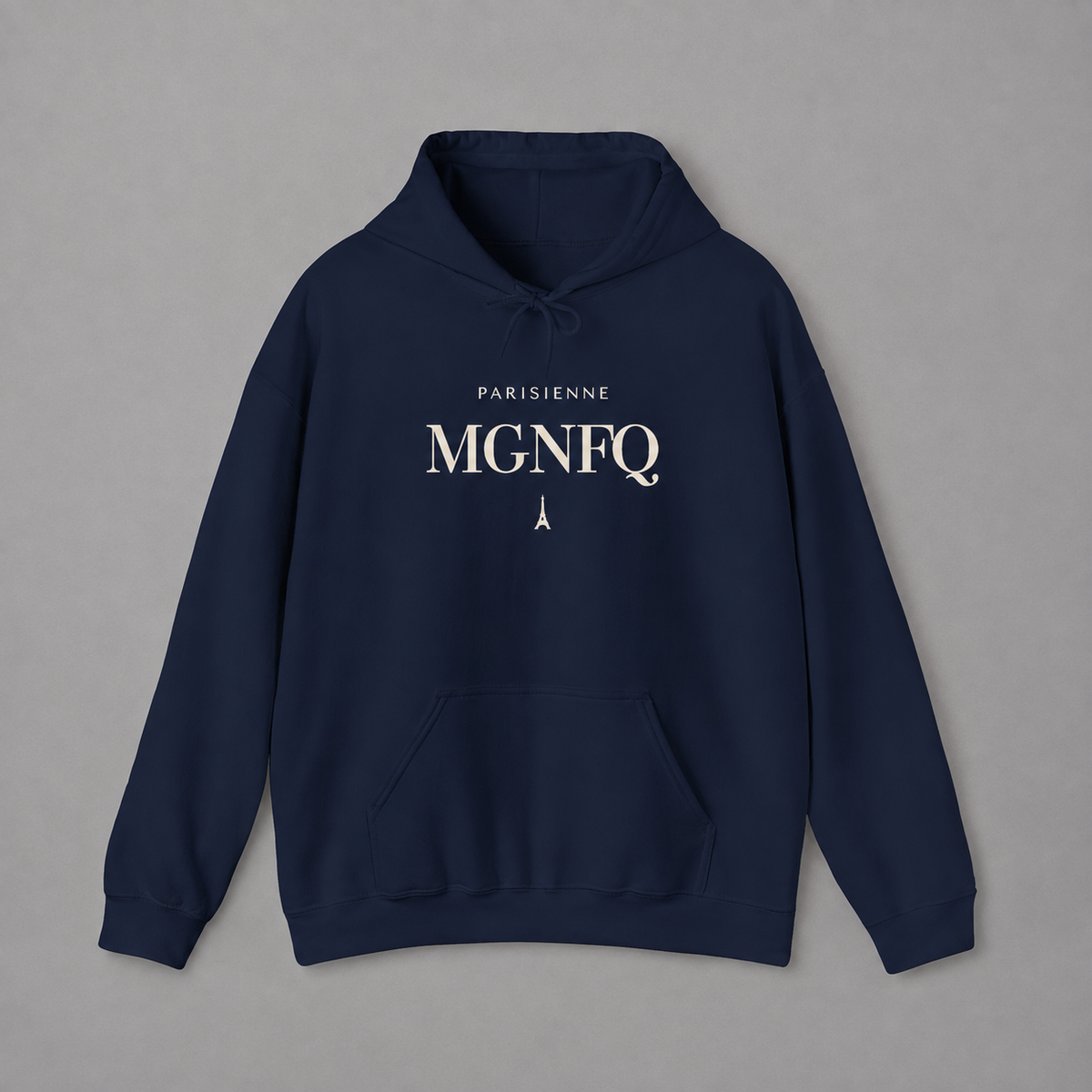 Navy blue PARISIENNE MGNFQ graphic hoodie featuring cream typography and a small Eiffel Tower detail, shown against a light gray studio background.