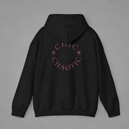 Black pullover hoodie shown from the back, featuring a dark burgundy circular CHIC CHAOTIC graphic with subtle star accents against a neutral gray studio background.