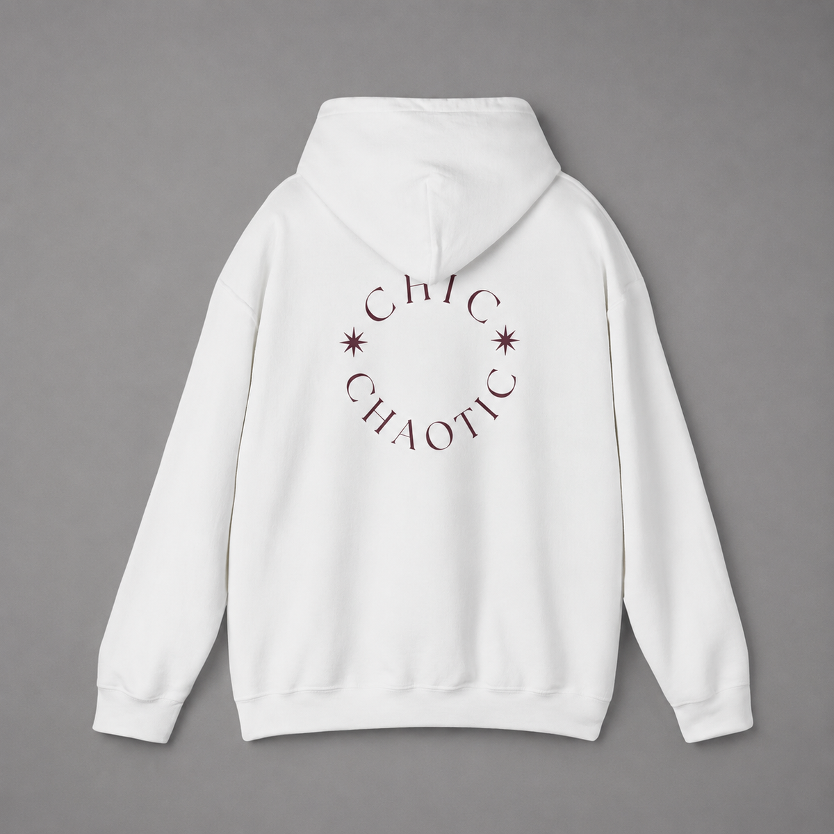 White pullover hoodie shown from the back, featuring a dark burgundy circular CHIC CHAOTIC graphic with subtle star accents against a neutral gray studio background.