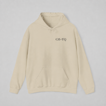 Beige pullover hoodie shown from the back, featuring a dark burgundy circular CHIC CHAOTIC graphic with subtle star accents against a neutral gray studio background.