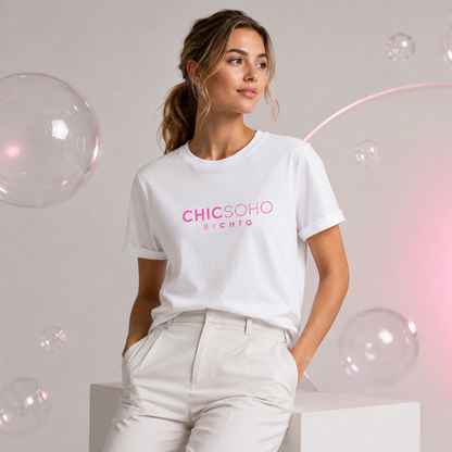 Woman wearing a white CHICSOHO graphic T-shirt with pink logo text and white trousers in a light gray editorial studio with floating bubbles and soft pink lighting.