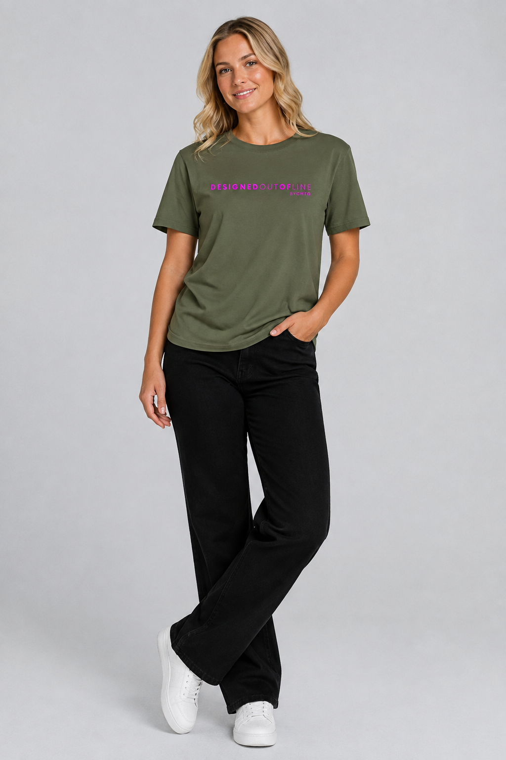 A woman modeling an olive green T-shirt with purple text that reads “DESIGNED OUT OF LINE” and “BY CHTQ” on the chest, paired with black pants and white sneakers, against a light gray studio background.