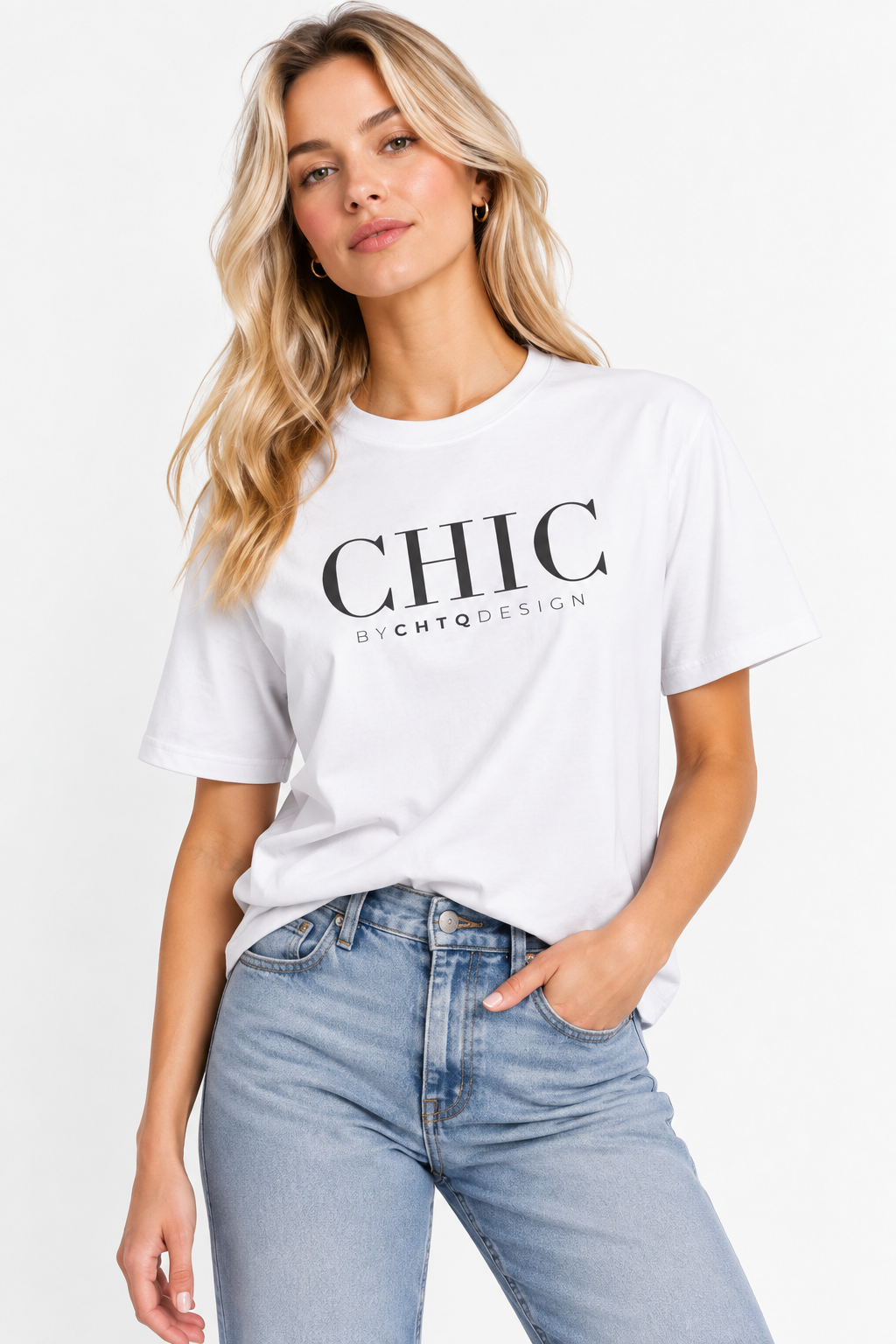 A woman wearing a white CHIC by CHTQ Design graphic T-shirt with black typography, paired with light blue jeans against a clean white studio background.