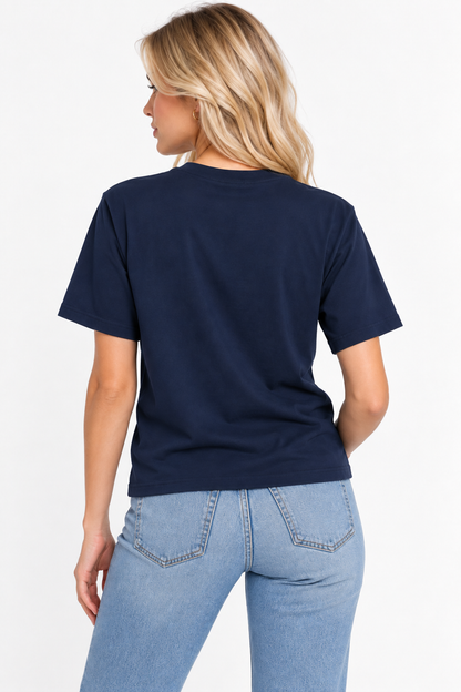 A woman viewed from the back wearing the CHIC by CHTQ Design Women’s Graphic T-Shirt in navy with light blue jeans against a clean white studio background.