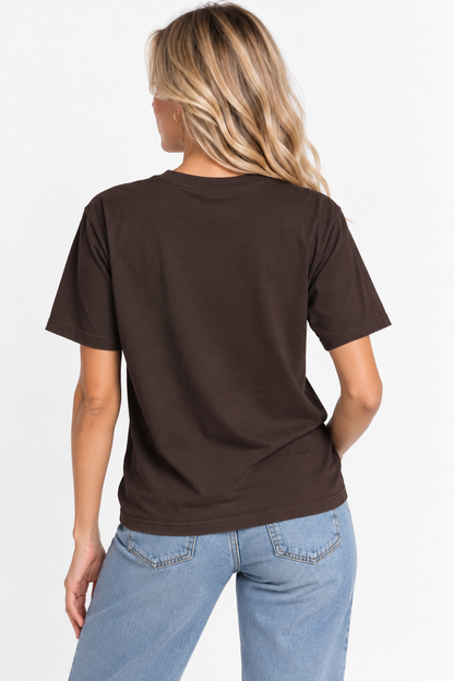A woman viewed from the back wearing the CHIC by CHTQ Design Women’s Graphic T-Shirt in brown with light blue jeans against a clean white studio background.