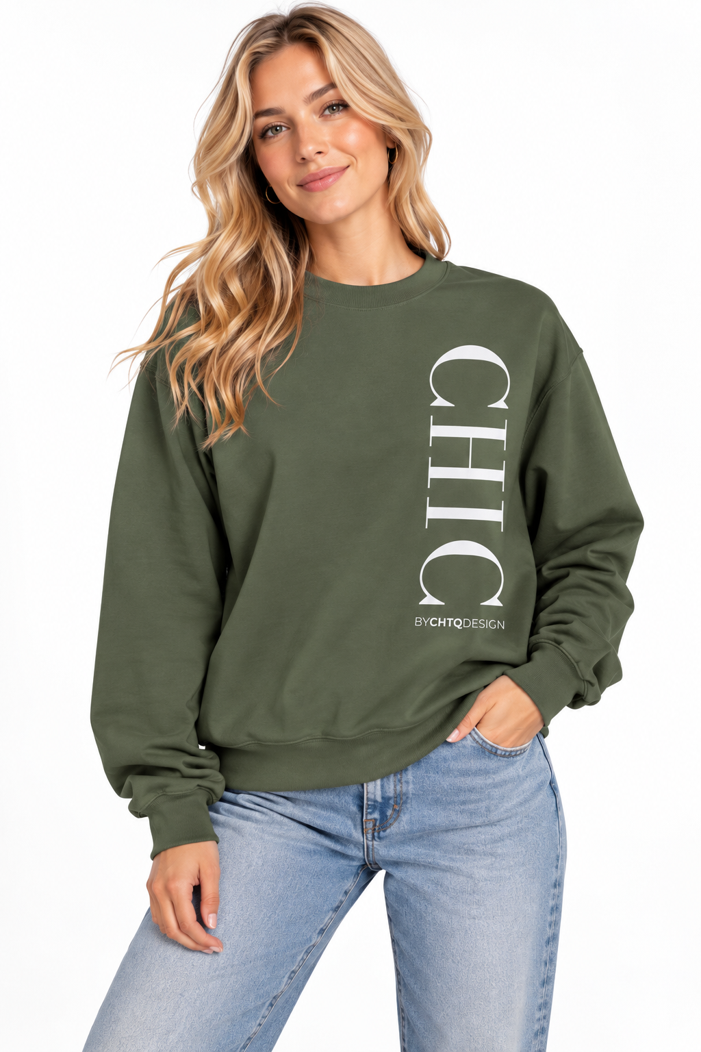 A woman wearing a green crewneck sweatshirt with a large vertical white 'CHIC' graphic and smaller 'BY CHTQ DESIGN' text, paired with light blue jeans against a plain white background.