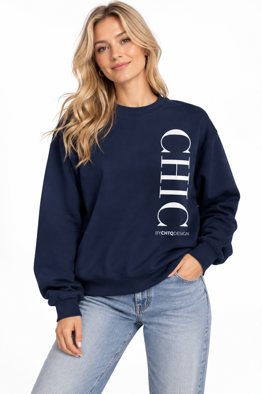 A woman wearing a navy crewneck sweatshirt with a large vertical white 'CHIC' graphic and smaller 'BY CHTQ DESIGN' text, paired with light blue jeans against a plain white background.
