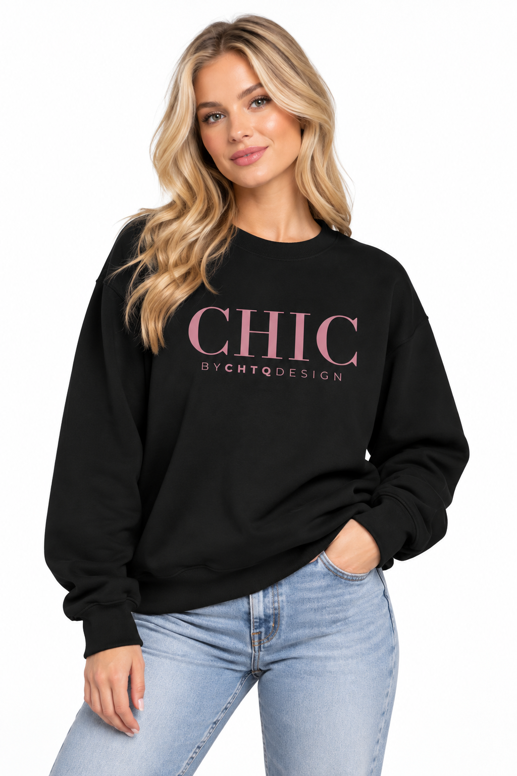 A woman wearing a black CHIC BY CHTQ DESIGN Crewneck Sweatshirt with a pink graphic across the chest, paired with light-wash blue jeans against a clean white studio background.