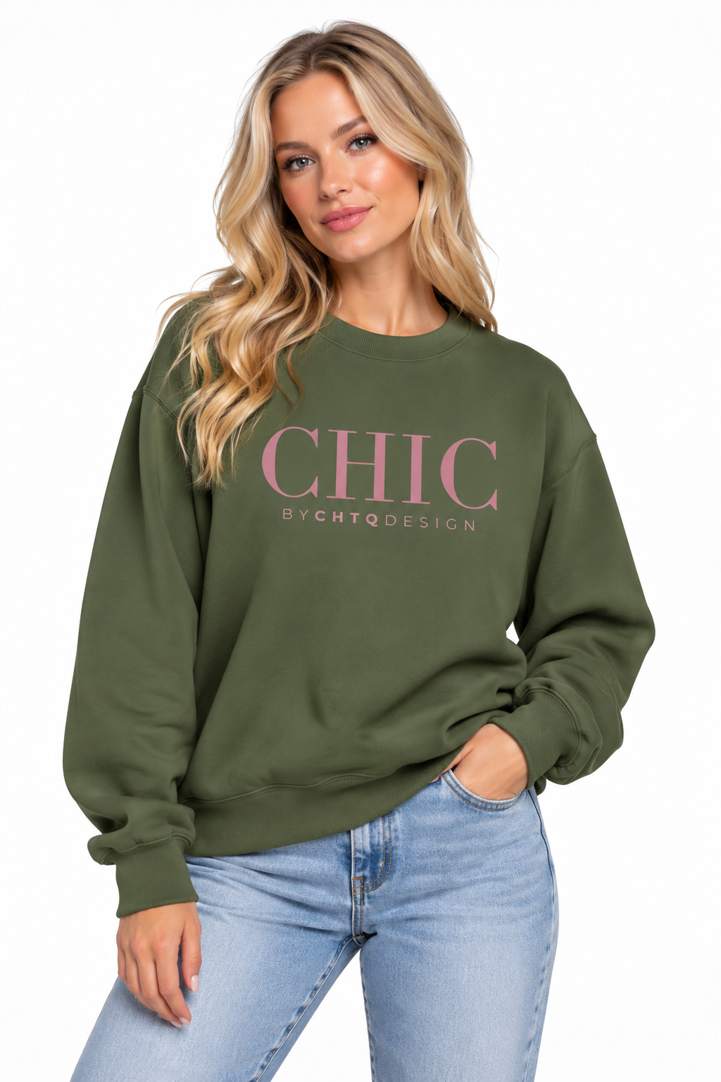 A woman wearing a green CHIC BY CHTQ DESIGN Crewneck Sweatshirt with a pink graphic across the chest, paired with light-wash blue jeans against a clean white studio background.