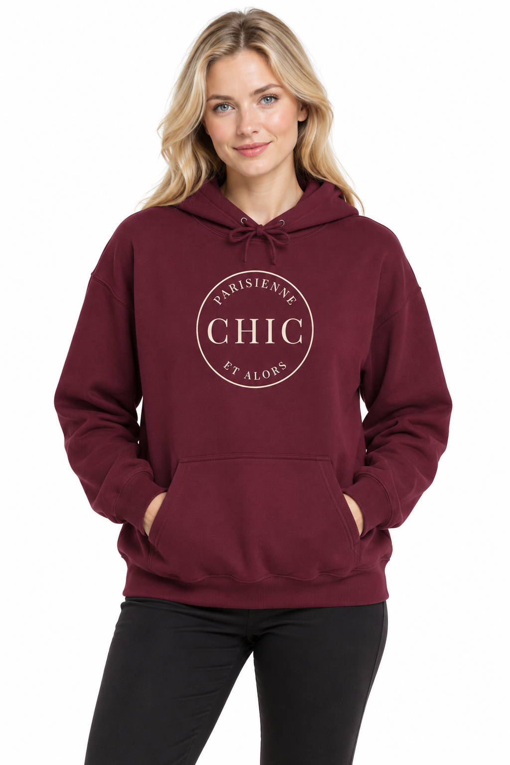 A woman wearing a burgundy pullover hoodie with a circular graphic on the chest that reads 'PARISIENNE CHIC ET ALORS', paired with black pants, against a plain white background.