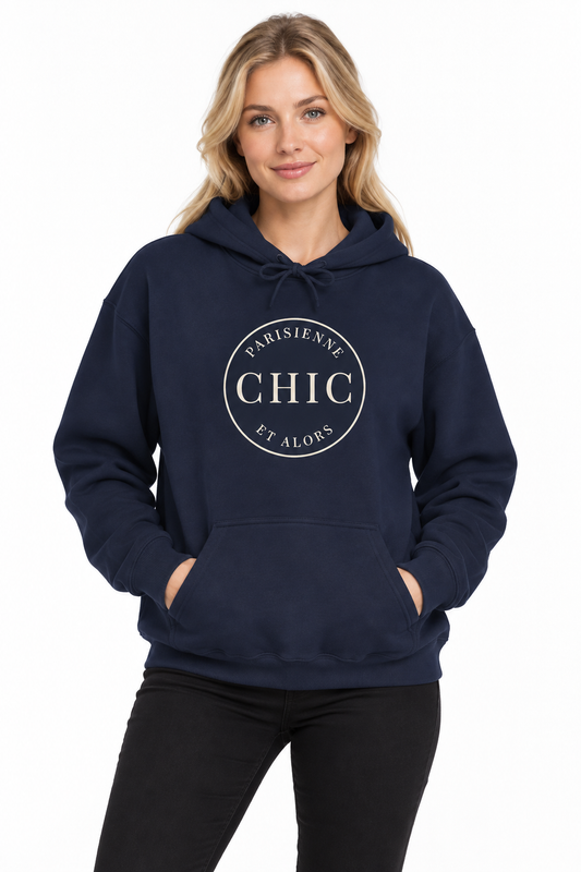 A woman wearing a navy blue pullover hoodie with a white circular graphic on the chest that reads 'PARISIENNE CHIC ET ALORS'.