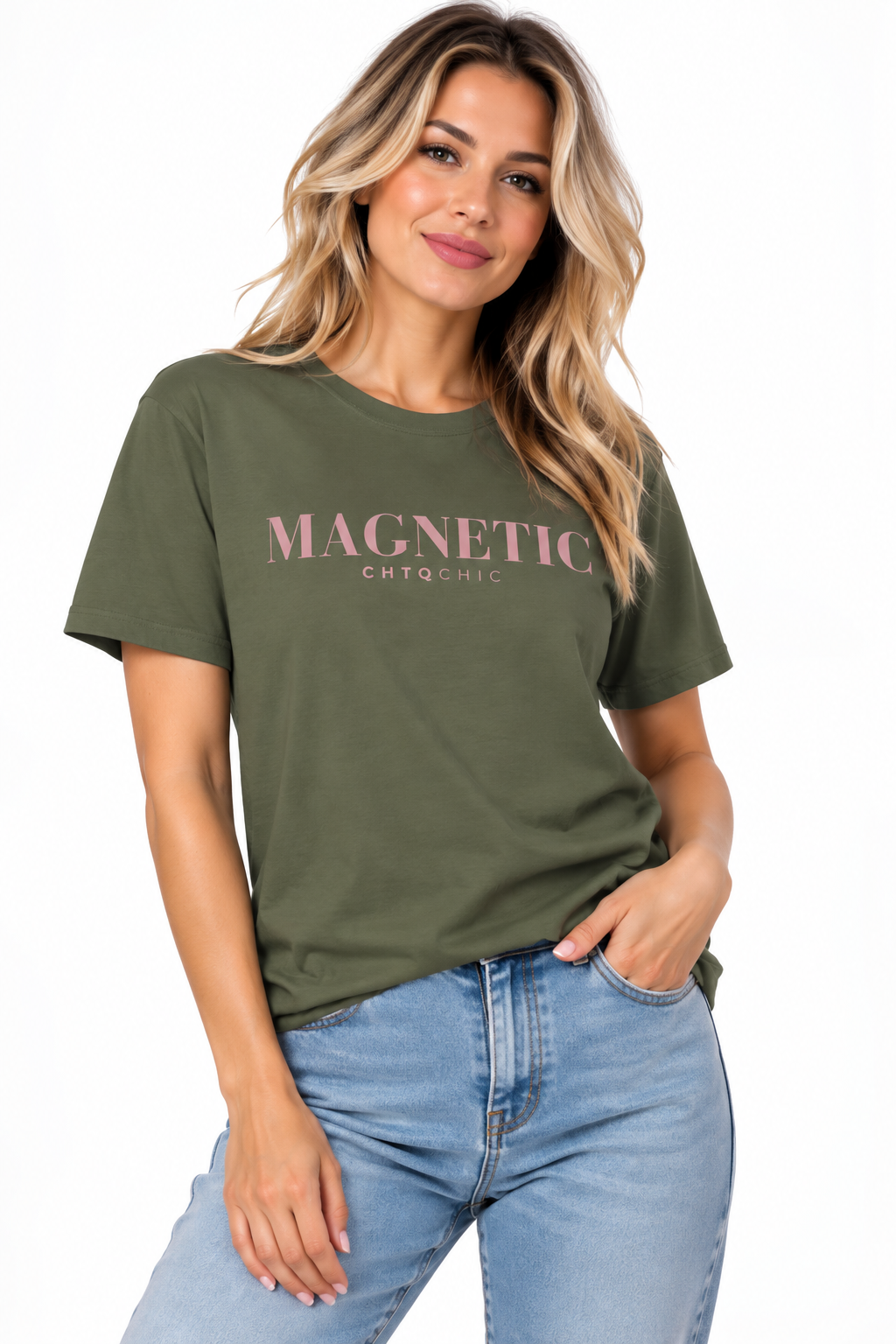 A woman wearing a green short-sleeve graphic T-shirt with 'MAGNETIC' and smaller 'CHTQ CHIC' text printed in pink across the chest, paired with light blue jeans, against a plain white background.