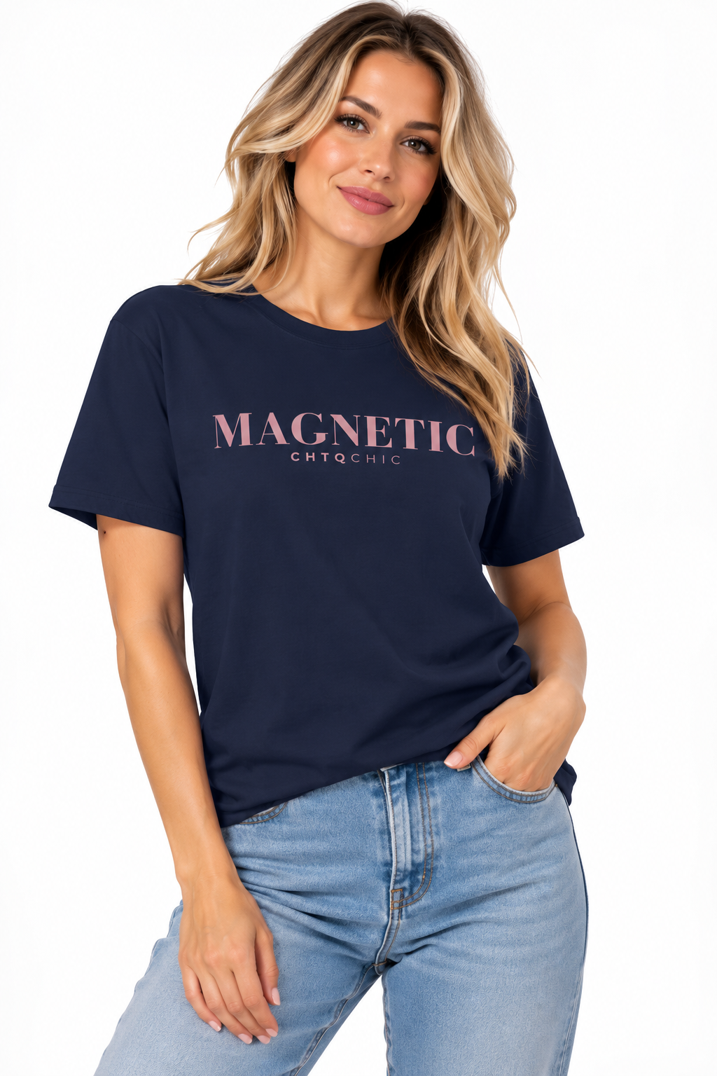 A woman wearing a navy short-sleeve graphic T-shirt with 'MAGNETIC' and smaller 'CHTQ CHIC' text printed in pink across the chest, paired with light blue jeans, against a plain white background.