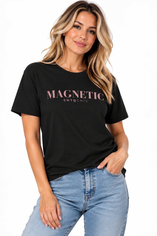A woman wearing a black short-sleeve graphic T-shirt with 'MAGNETIC' and smaller 'CHTQ CHIC' text printed in pink across the chest, paired with light blue jeans, against a plain white background.