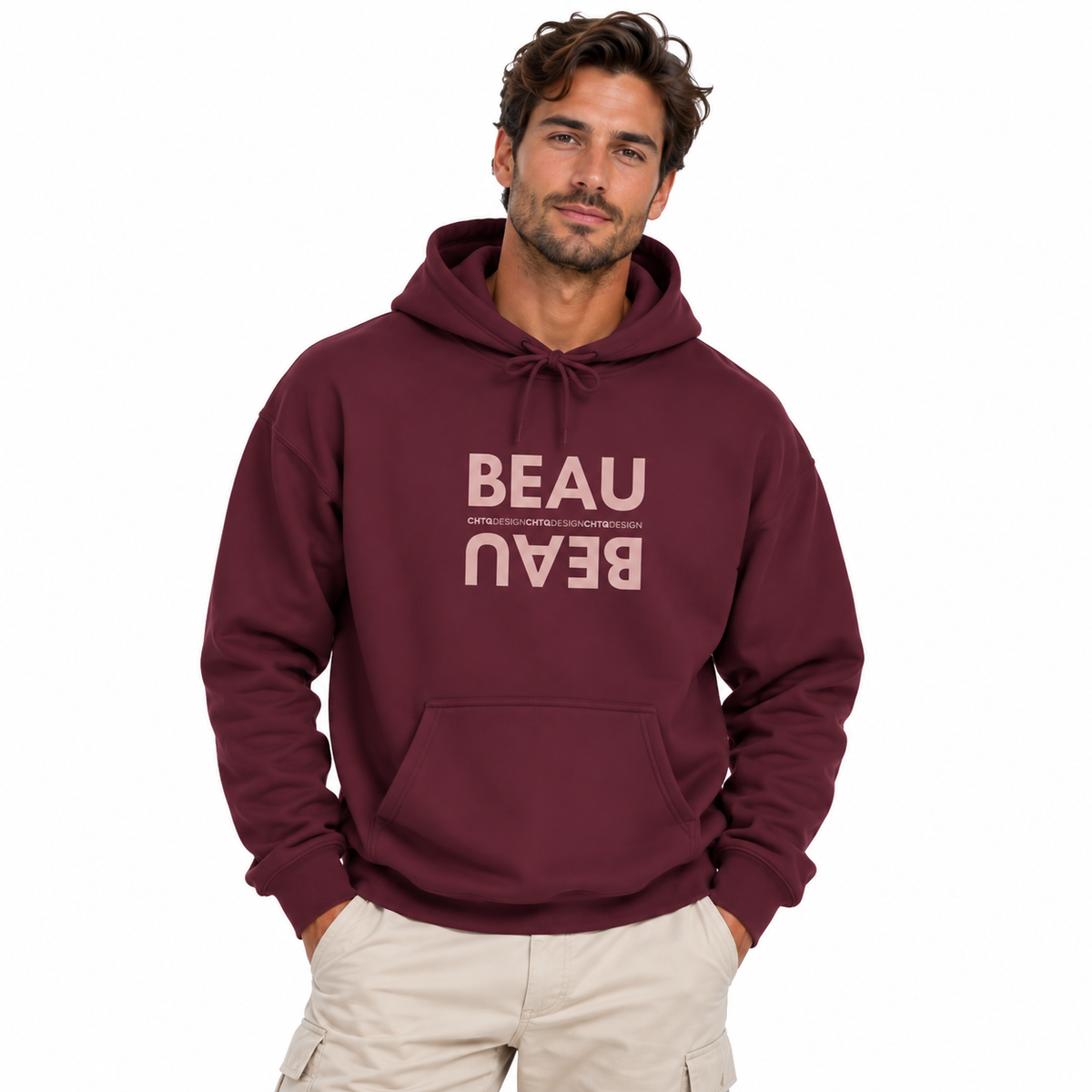 A man modeling a maroon BEAU graphic hoodie with a mirrored dusty pink BEAU print and CHTQ Design detail on the chest, paired with beige pants against a white studio background.