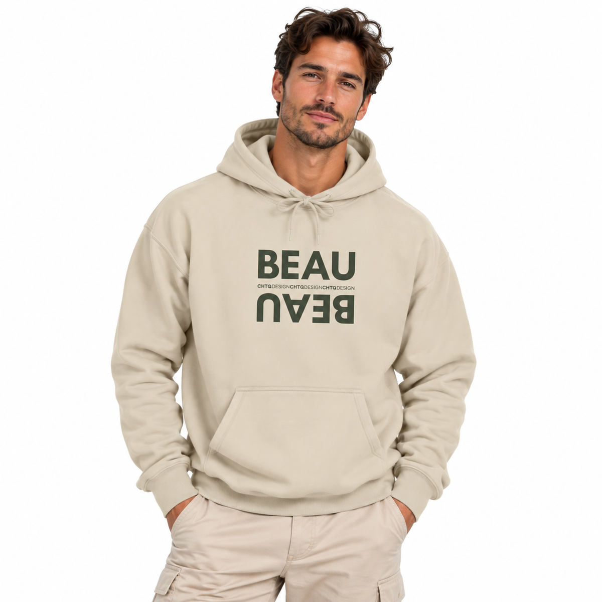 A man wearing a beige pullover hoodie with dark green text reading 'BEAU' and smaller text below, paired with matching beige pants, against a plain white background.