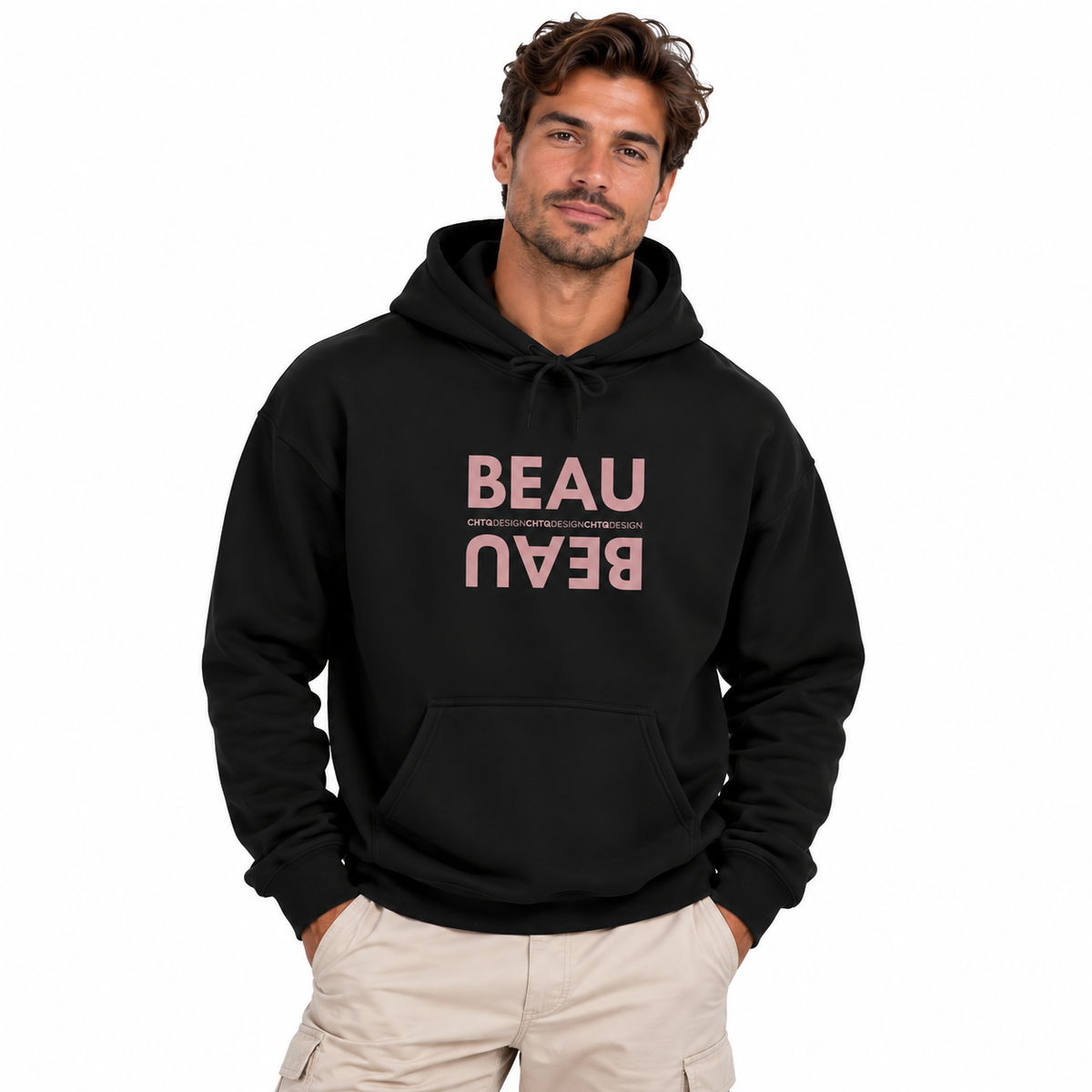 A man modeling a black BEAU graphic hoodie with a mirrored dusty pink BEAU print and CHTQ Design detail on the chest, paired with beige pants against a white studio background.