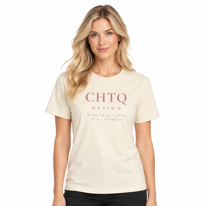 A woman modeling a cream-colored short-sleeve t-shirt with 'CHTQ DESIGN' printed in dusty pink on the chest, paired with black pants against a plain white background.