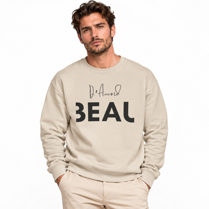 Male model wearing a sand BEAU D’ACCORD graphic crewneck sweatshirt with black lettering against a white studio background.