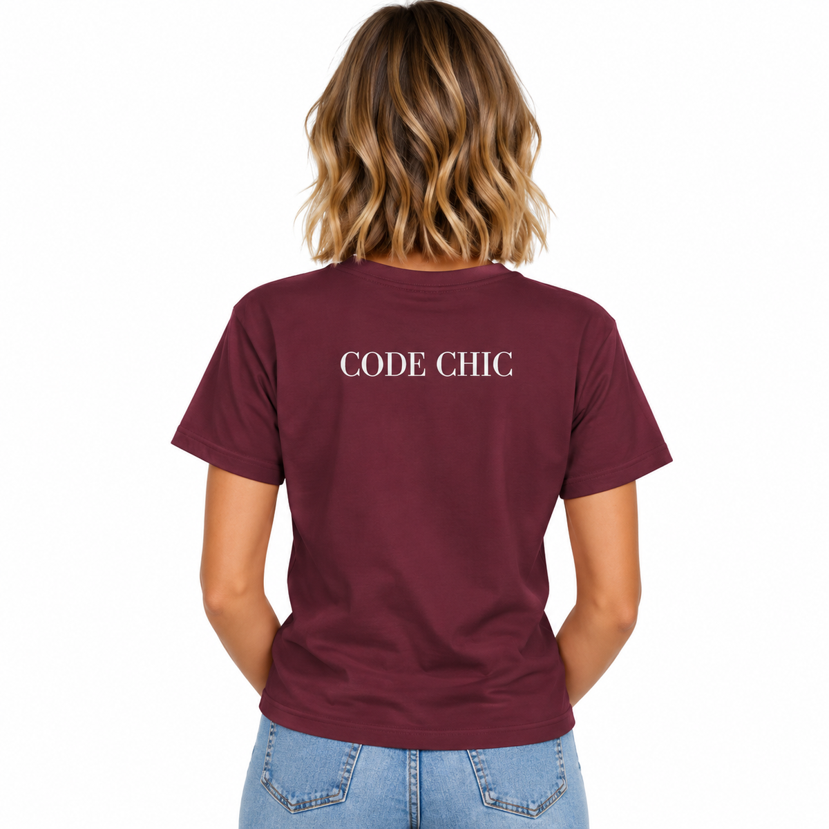 A woman viewed from behind wearing a maroon short-sleeve t-shirt with 'CODE CHIC' printed in white serif letters across the upper back, paired with light blue jeans against a plain white background.