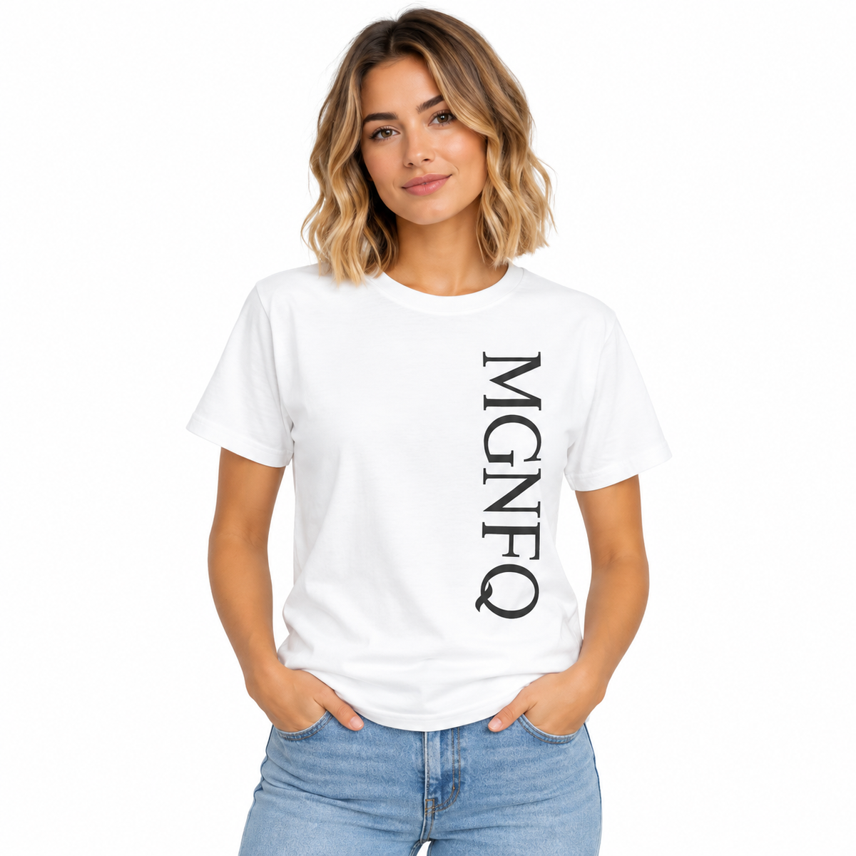 A woman wearing a white short-sleeve T-shirt with “MGNFQ” printed vertically in black on the front, paired with light blue jeans against a plain white studio background.
