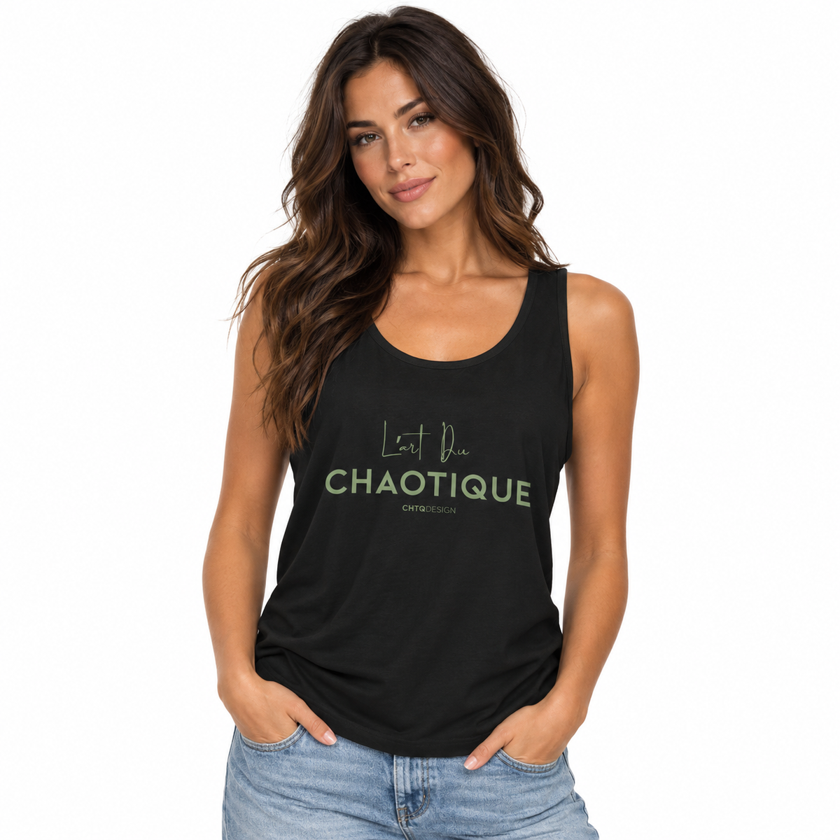 A woman modeling a black racerback tank top with 'L'art Du CHAOTIQUE' printed in light green on the front, paired with light wash blue jeans against a plain white background.