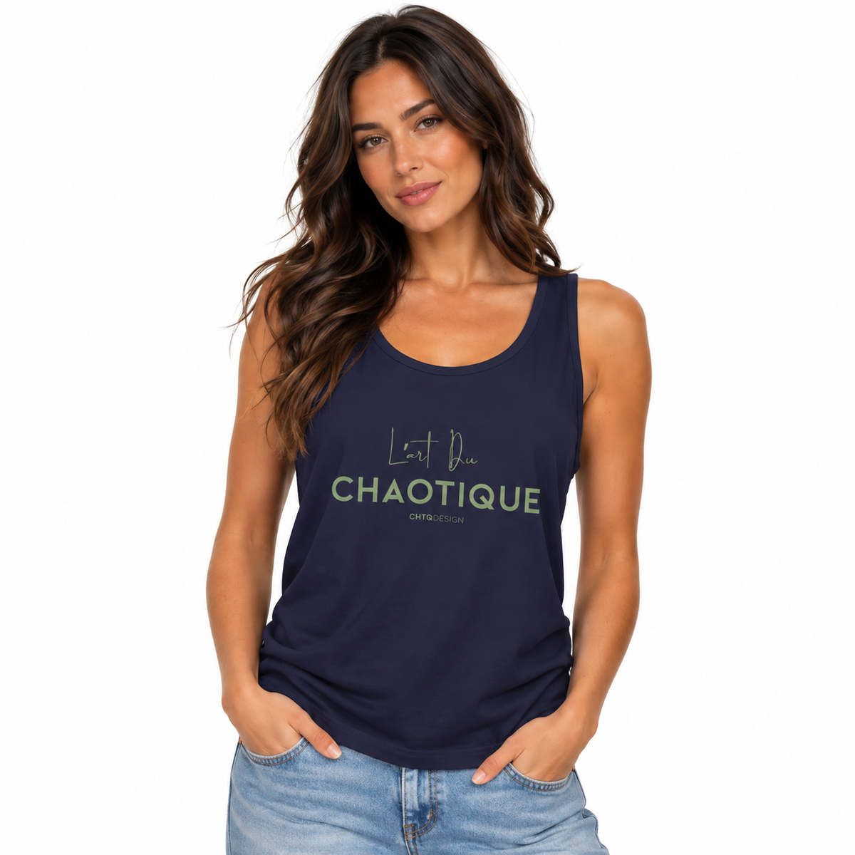 A woman modeling a navy blue tank top with 'L'Art Du CHAOTIQUE' printed in light green and white on the front, paired with light wash blue jeans against a plain white background.