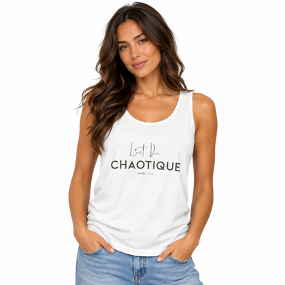 A woman modeling a white sleeveless tank top with black text that reads 'L'art du Chaotique' on the front, paired with light blue jeans against a plain white background.