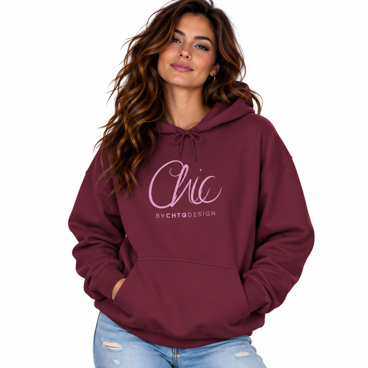A woman wearing a maroon pullover hoodie with a light pink 'Chic BY CHTQ DESIGN' graphic on the chest, paired with light-wash distressed jeans, against a plain white background.