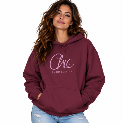 A woman wearing a maroon pullover hoodie with a light pink 'Chic BY CHTQ DESIGN' graphic on the chest, paired with light-wash distressed jeans, against a plain white background.