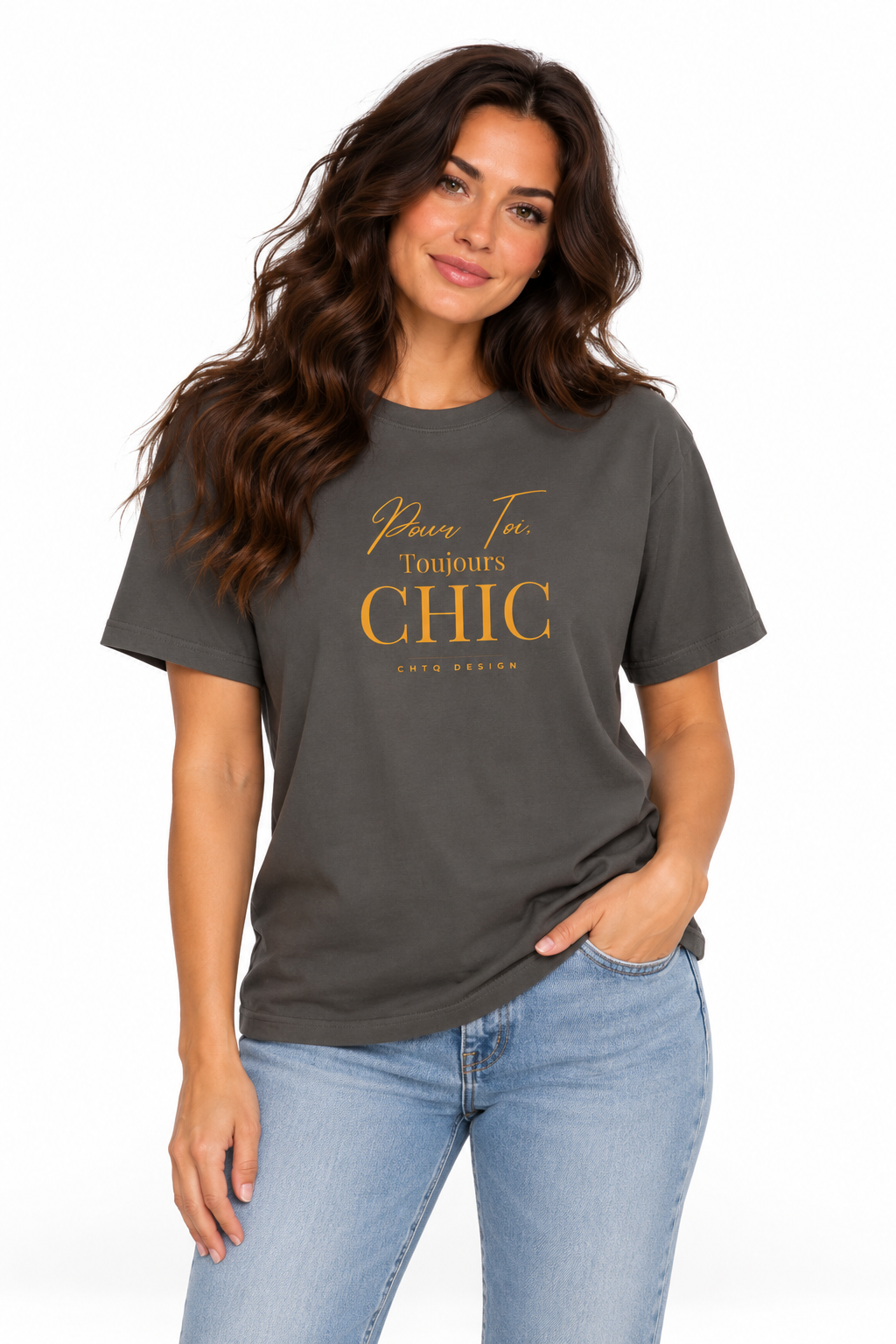 A woman modeling a dark charcoal gray t-shirt with gold text that reads 'Pour Toi Toujours CHIC' and 'CHTQ Design', paired with light blue jeans against a plain white background.