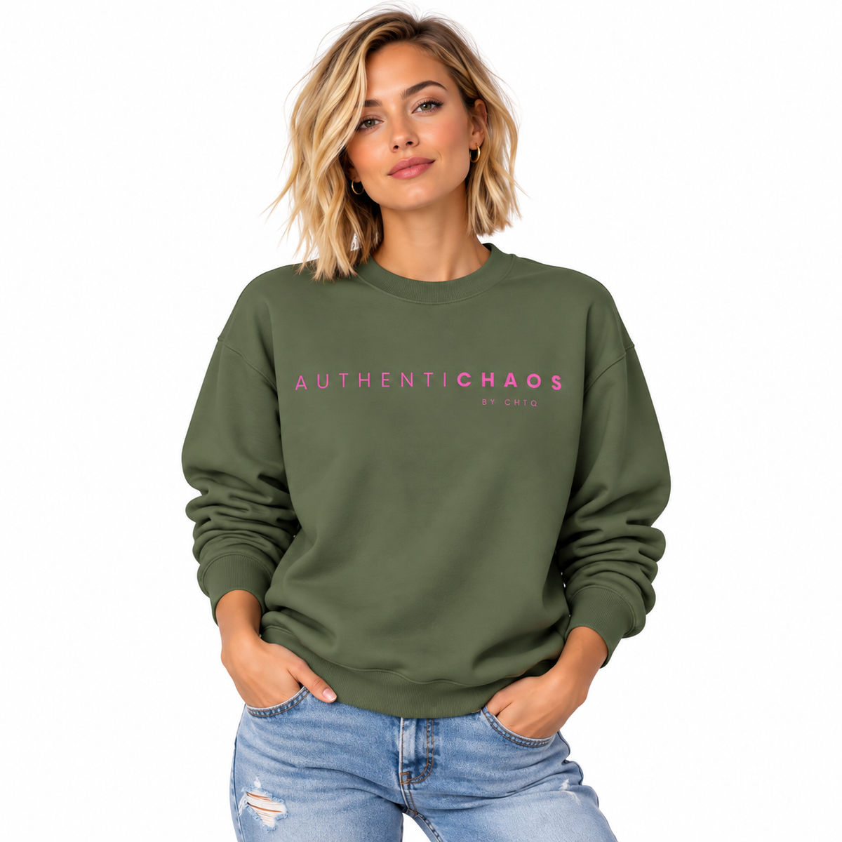 Woman wearing a Military green AUTHENTICHAOS graphic sweatshirt with pink BY CHTQ typography, front view